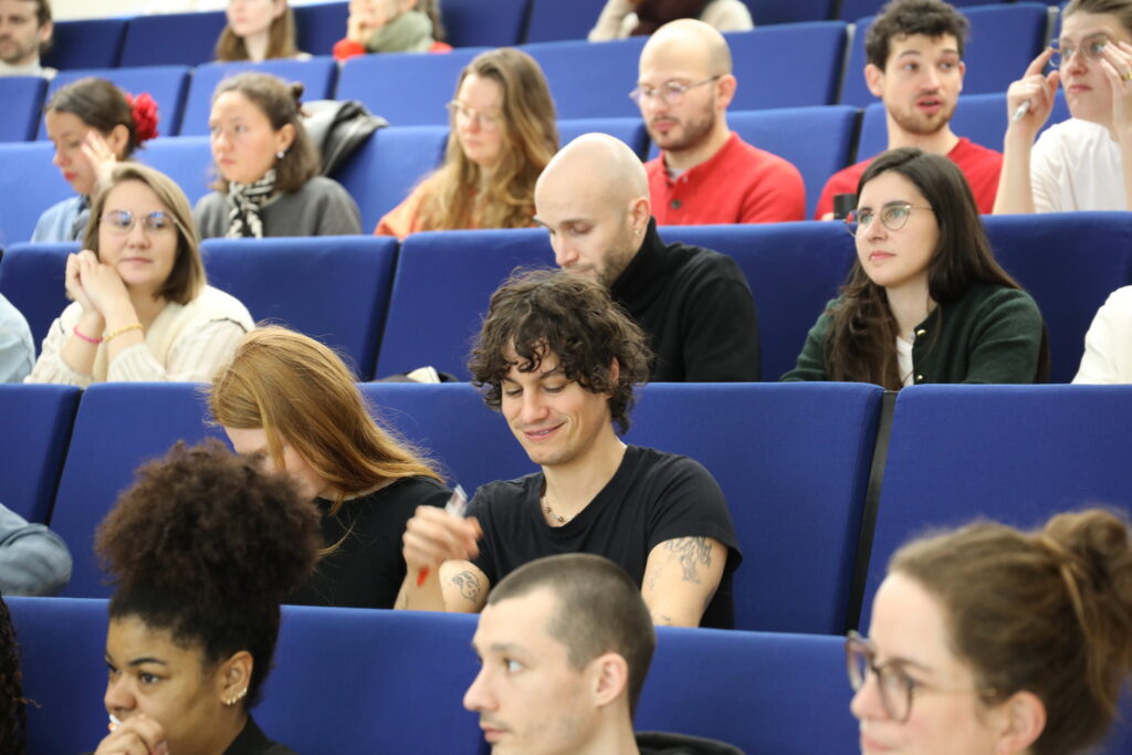 Des enseignants écoutent une conférence dans un amphithéâtre.